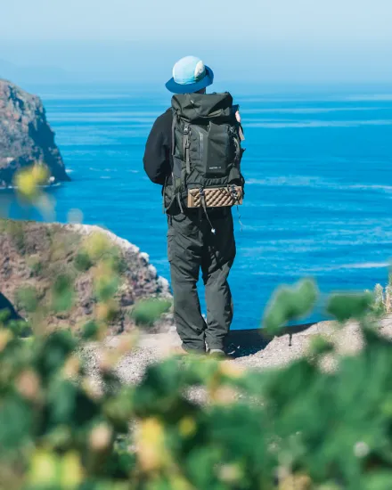 Ryan facing the ocean, on the edge of a cliff
